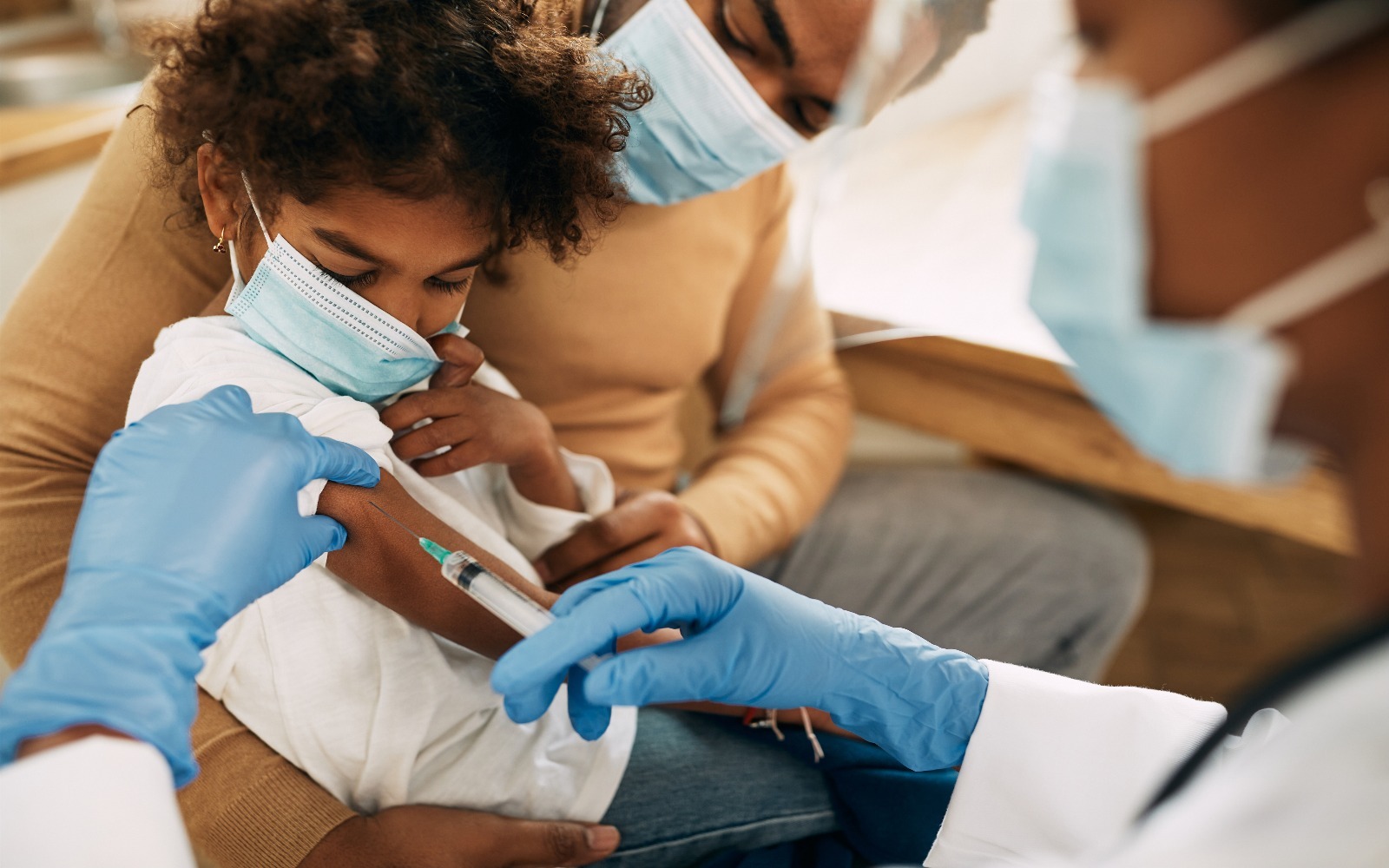 african-american-small-girl-receiving-covid19-vaccine-medical-clinic